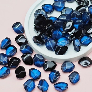 Macro shot of faceted dark blue and black glass beads for DIY jewelry making