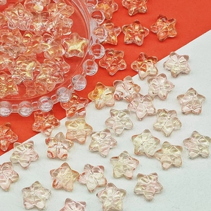 Macro shot of translucent star-shaped beads with orange patterns for DIY jewelry making