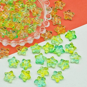 Close-up of translucent orange and green flower beads for handmade DIY hairpins