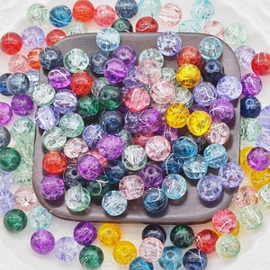 Colorful 10mm cracked glass beads set in a wooden tray for DIY jewelry making