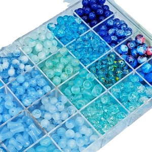 DIY jewelry making kit with blue glass beads in various textures and storage box