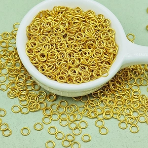 Macro view of polished gold-plated jump rings for DIY jewelry making and linking