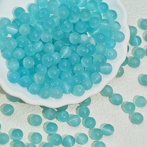 Macro shot of light blue cat eye beads with chatoyancy effect for DIY jewelry making