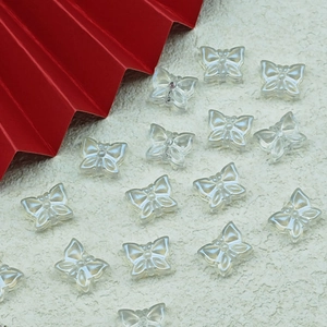 Detailed macro view of pearlescent translucent butterfly resin beads for DIY jewelry making