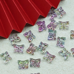 Macro detail of iridescent glass butterfly beads for DIY jewelry making with AB coating