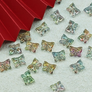 Macro view of transparent colorful glass butterfly beads with detailed wing texture