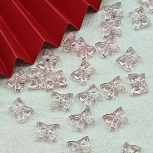 Detailed view of pink translucent butterfly resin beads for DIY jewelry and accessories