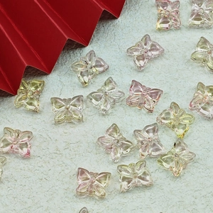 Detailed view of colorful transparent butterfly charms for DIY jewelry making