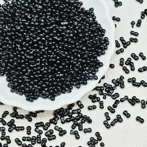 Macro shot of unique black double-hole dumbbell seed beads for DIY jewelry making
