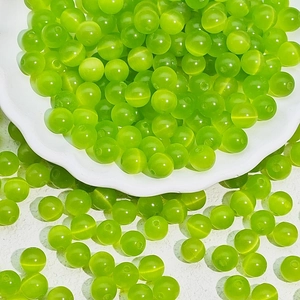Macro detail of green cat-eye beads with polished finish for DIY jewelry crafting