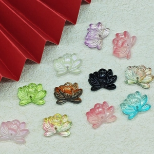 Flat lay of colorful lotus flower charms with drill holes for DIY jewelry making