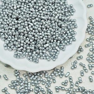 Macro view of matte silver 2-hole peanut spacer beads for handmade jewelry design