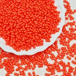 Macro shot of 3x6mm orange glass peanut beads with double holes for jewelry making