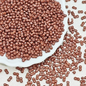 Macro shot of 3x6mm reddish brown dual-hole glass peanut beads for DIY jewelry making