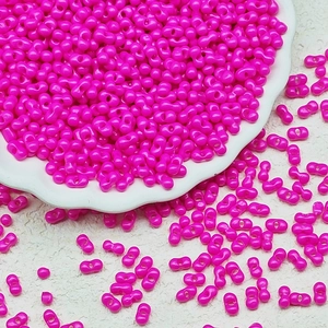 Detail shot of bright rose red twin seed beads with double holes for DIY jewelry making