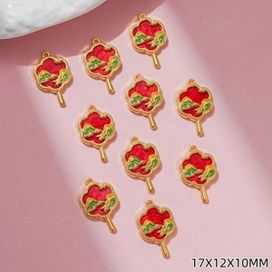 Detailed view of 10 gold fan charms with red mountain patterns in 17x12x10mm size