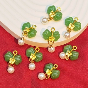 Bow-shaped green faux jade charms with pearls and gold accents for DIY jewelry making