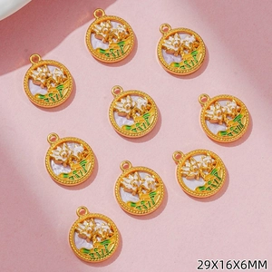 Macro detail of nine lotus enamel pendants with gold finish measuring 29x16x6mm