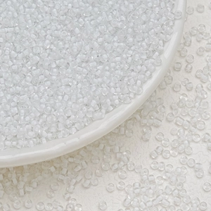 Close-up of 3mm transparent white glass seed beads for DIY jewelry making and tassels