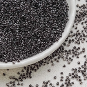 Macro shot of 3mm smoke gray glass seed beads for DIY handmade jewelry crafts