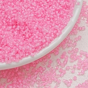Macro view of 3mm pink dyed-core glass seed beads for DIY jewelry making and crafts