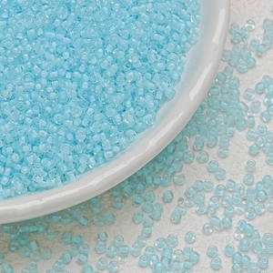 3mm light blue glass seed beads in a white bowl for DIY jewelry making and beadwork