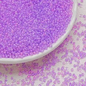 Detailed macro view of 3mm lavender purple glass seed beads for DIY jewelry making