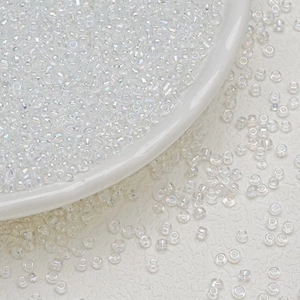 Macro shot of 3mm transparent iridescent glass seed beads for DIY jewelry making