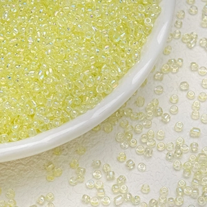 Macro shot of 3mm iridescent pale yellow glass seed beads for DIY jewelry making