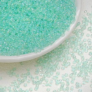 Close-up of 3mm mint green glass seed beads with iridescent AB coating for DIY jewelry