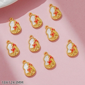 Macro view of 9pcs gold-plated gourd charms with white enamel and red floral patterns