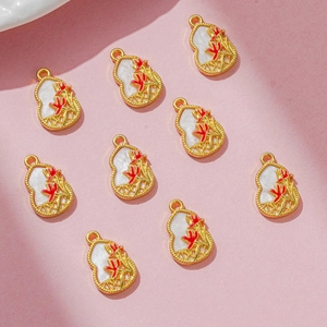 Golden gourd-shaped DIY charms with white inlay and red floral details for jewelry making