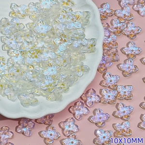 Macro detail of 10mm iridescent four-petal flower beads for DIY jewelry making