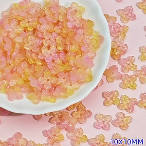 Macro view of 10mm yellow and pink gradient glass flower beads for DIY jewelry making