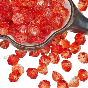 Translucent red lotus flower glass beads for DIY jewelry making on white background
