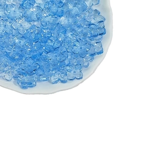 Blue 10mm Czech glass flower beads for DIY jewelry making piled on a white plate