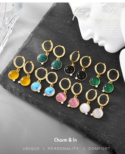 Detailed view of colorful natural stone hoop earrings with gold finish and zircon accents