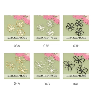 Detailed view of hollow metal flower charms in gold, silver, and black finishes