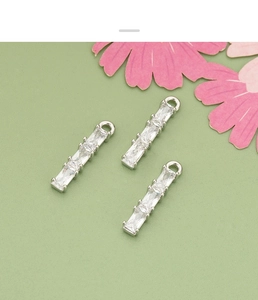 Close-up of three 18k gold plated bamboo pendants with rectangular clear cubic zirconia