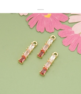 Macro shot of 18k gold plated baguette-cut colorful zircon pendant for DIY jewelry