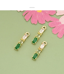 Macro detail of 18k gold plated bamboo pendant with gradient green zircon gemstones