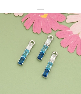 Macro detail of gradient blue crystal bamboo pendants in 18k gold plated copper setting
