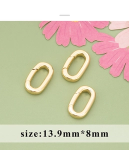 Detail of three 13.9mm golden oval spring clasps for DIY jewelry making and necklaces