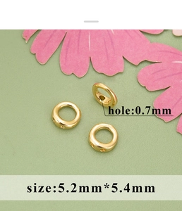 Detail view of 5.2mm gold-plated brass bead tips with 0.7mm holes for jewelry making