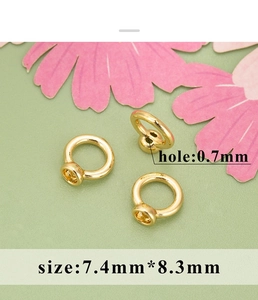 Macro detail of 18K gold plated jewelry connectors showing 0.7mm hole and 7.4x8.3mm size