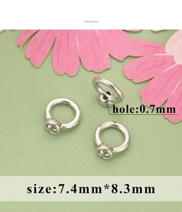 Detailed macro view of silver-plated copper pearl connector with 0.7mm hole size