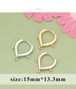 Detailed view of U-shaped gold-plated earring hoops with three small hanging loops