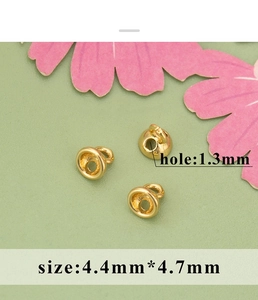 Detailed view of 1.3mm hole gold plated pearl connector caps for jewelry making