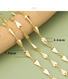 Macro detail of 18k gold plated drop-shaped chain links measuring 7.9mm by 4.6mm