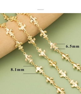 Detail of 18k gold-plated fleur-de-lis chain links with 6.5mm and 8.1mm size dimensions